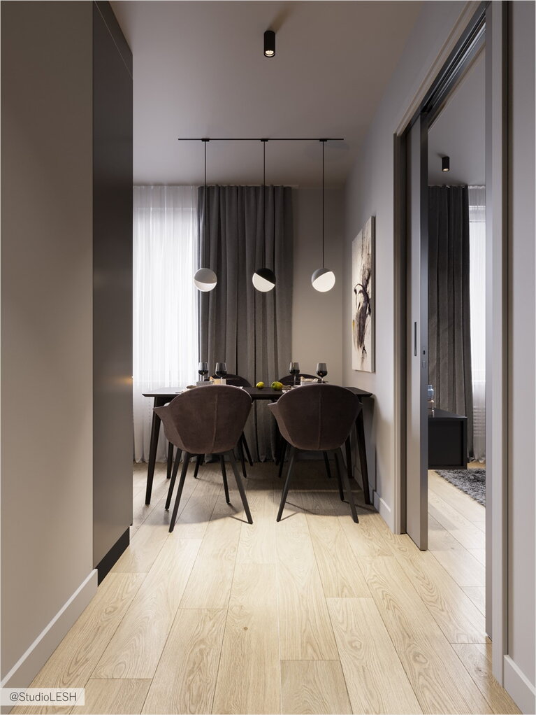 Corridor in the kitchen overlooking the dining group in dark gray colors with eye-catching chairs
