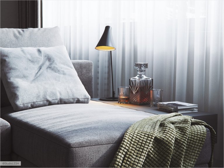 Gray light sofa in the kitchen-living room with the accent light from the reading lamp