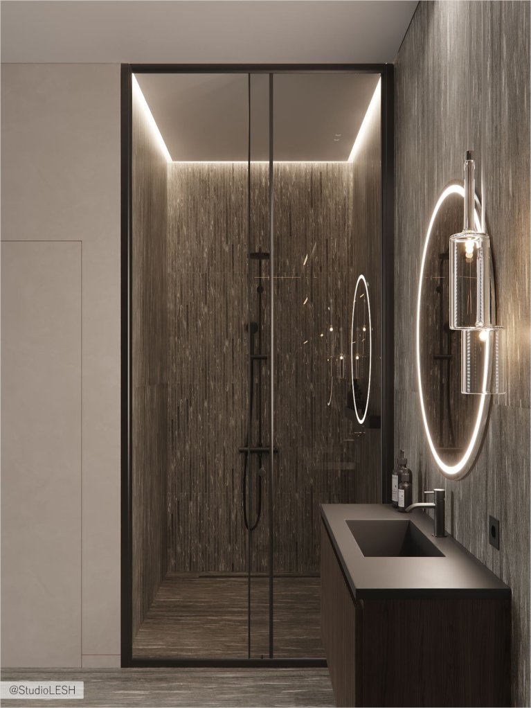 Подвесная тумба с раковиной, черная сантехника и круглое зеркало с подсветкой в современной ванной комнате с отделкой под камень