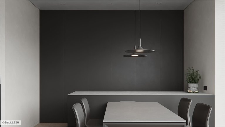 Интерьер современной кухни: темные минималистичные фасады, встроенная техника, подсветка, серый обеденный стол с двумя современными стульями, светлый ламинат на полу.