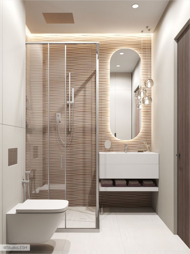 Просторная ванная комната с душевой кабиной, отделанной под дерево, и подвесным унитазом. Овальное зеркало с подсветкой добавляет современности, а подвесная тумба с раковиной - функциональности