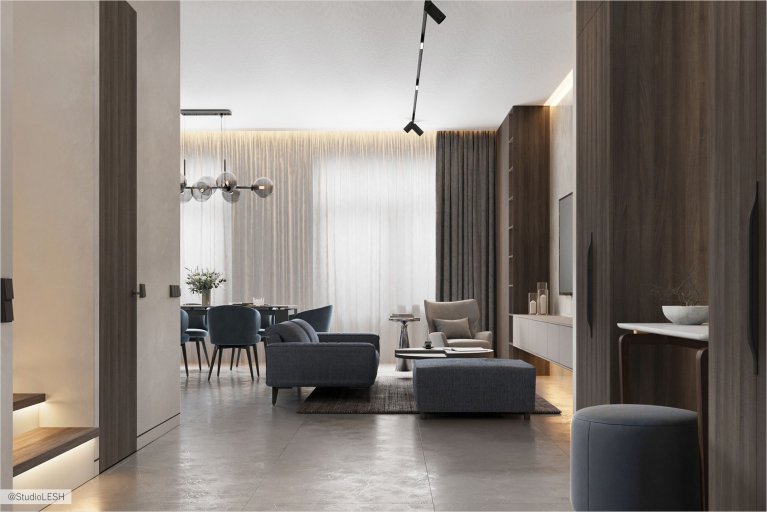 Стильная и современная гостиная, где каждый элемент имеет свое место. Серая мебель гармонично сочетается со светлым полом, создавая ощущение гармонии и спокойствия. Игра света и тени подчеркивает глубину пространства и создает уютную атмосферу
