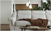  Wooden coffee table in the living room with a white sofa.